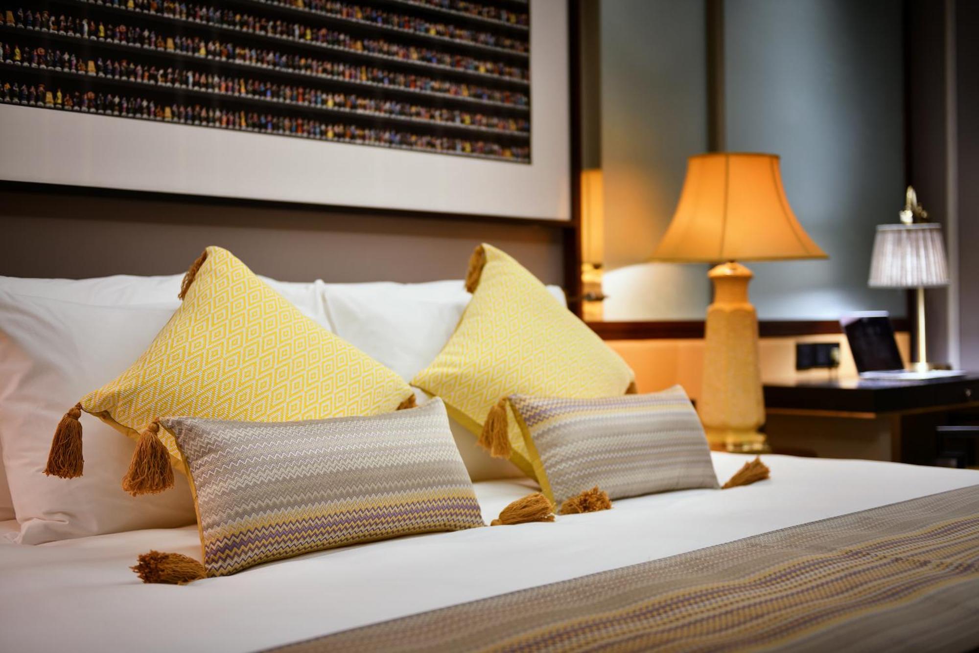 Silk Path Grand Sapa Resort & Spa Екстериор снимка A bed with cushions